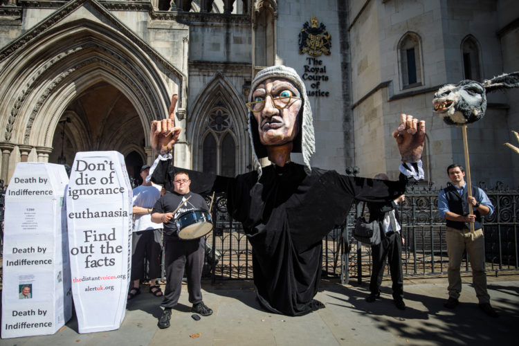 Opponents outside court with fake coffins